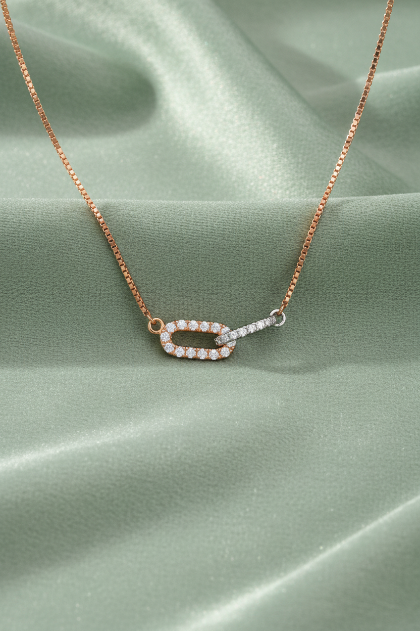 Rose Gold Paperclip Necklace on Sage Green Fabric